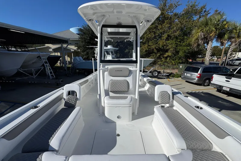 Slide: The Image of 2026 Caymas 281 HB boat with spacious seating and modern design in a marina setting. - 25
