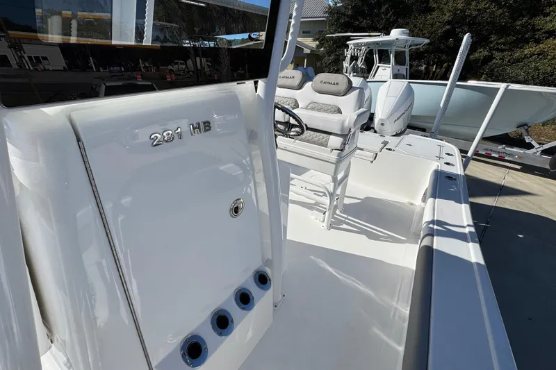 Slide: The Image of 2026 Caymas 281 HB boat interior with seating and console details. - 26
