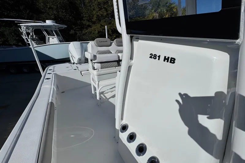 Slide: The Image of 2026 Caymas 281 HB boat interior with seating and console details. - 27