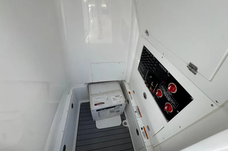 Slide: The Image of Interior view of 2026 Caymas 281 HB boat's electrical panel and storage area. - 28