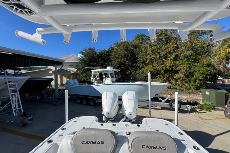Slide: The Image of 2026 Caymas 281 HB boat in marina, featuring dual engines and sleek design. - 31