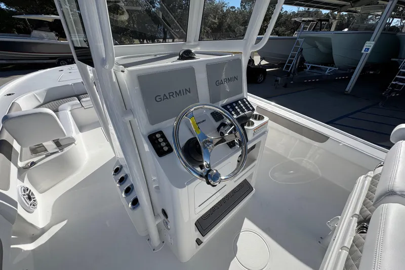 Slide: The Image of 2026 Caymas 281 HB boat helm with dual Garmin displays and steering wheel. - 32