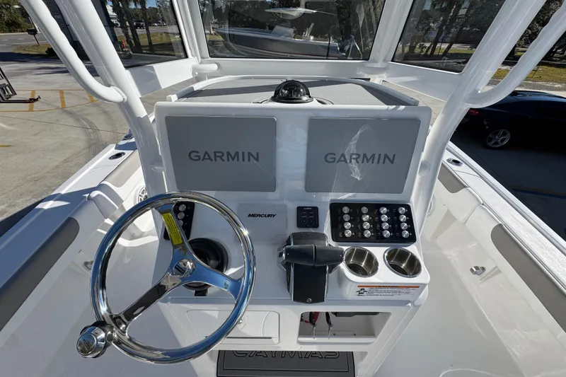 Slide: The Image of 2026 Caymas 281 HB boat dashboard with Garmin displays and Mercury controls. - 33