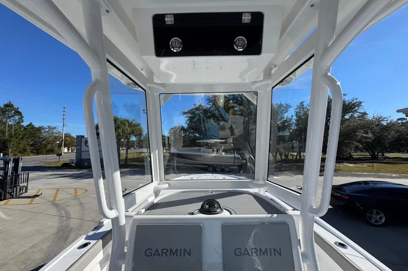 Slide: The Image of 2026 Caymas 281 HB boat interior with Garmin navigation system, clear blue sky background. - 34