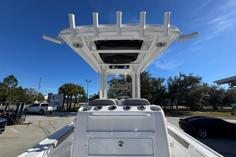 Slide: The Image of 2026 Caymas 281 HB boat with T-top and rod holders under clear blue sky. - 38