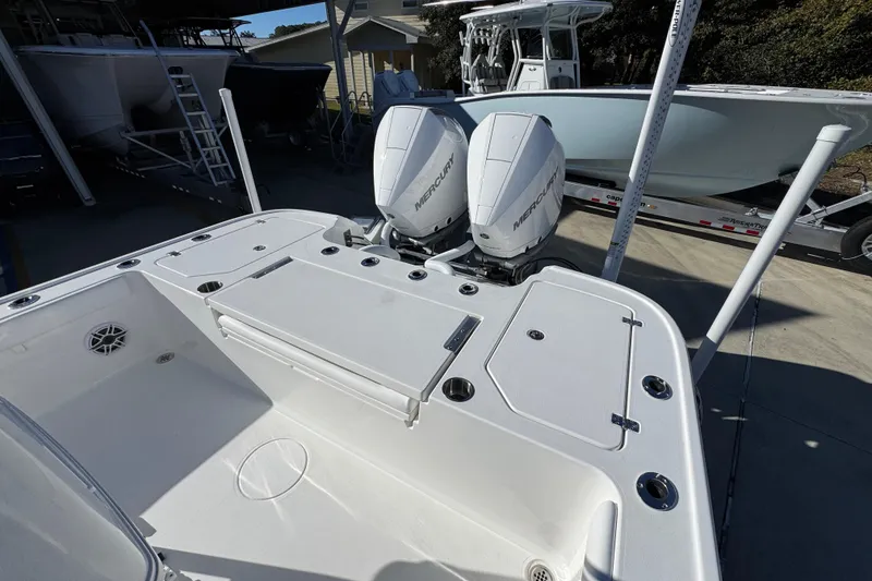 Slide: The Image of 2026 Caymas 281 HB boat with dual Mercury engines, docked outdoors. - 39