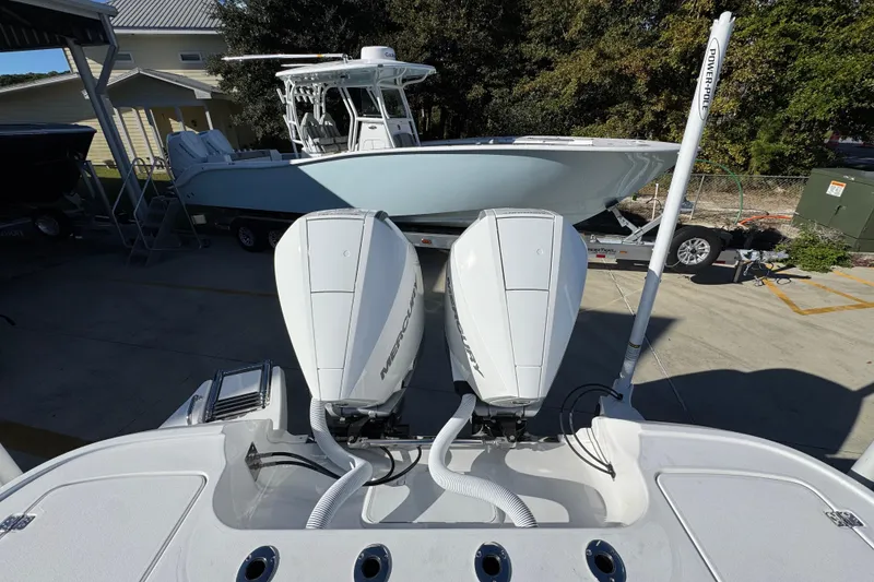 Slide: The Image of 2026 Caymas 281 HB boat with dual Mercury engines, docked outdoors. - 43