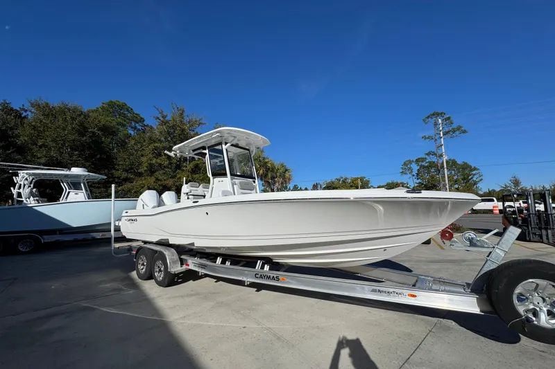 Slide: The Image of 2026 Caymas 281 HB boat on trailer under clear blue sky. - 9