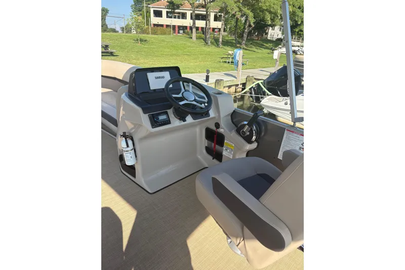 Slide: The Image of 2024 Harris HCX23 boat helm with steering wheel and control panel. - 5