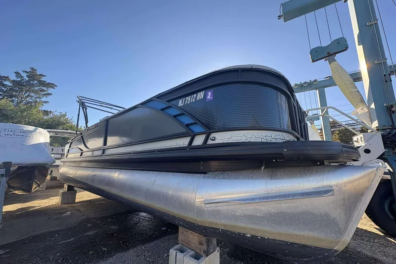 The Image of 2020 Godfrey Monaco 25 pontoon boat on dry dock, side view. - 1