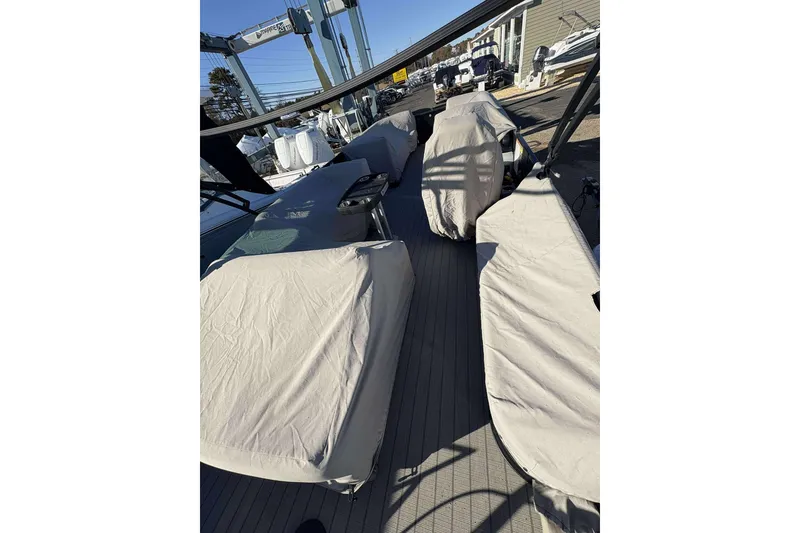 Slide: The Image of Covered seating area on a 2020 Godfrey Monaco 25 boat, docked outdoors. - 11