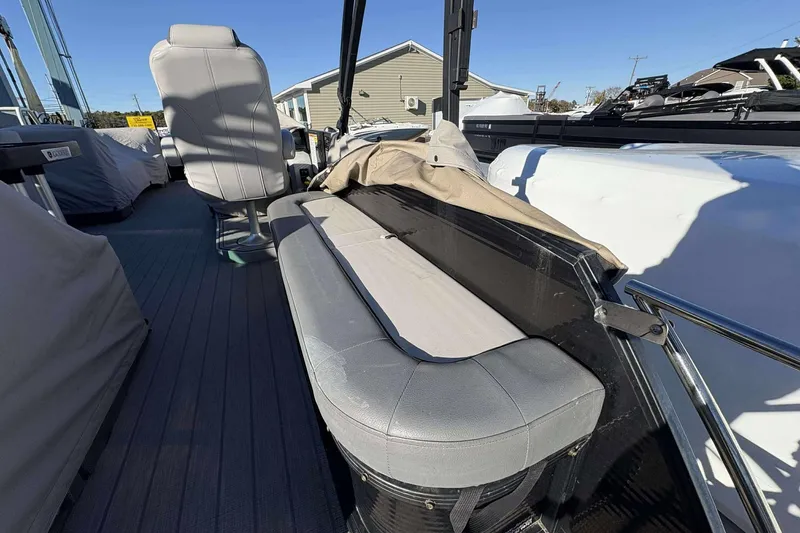 Slide: The Image of 2020 Godfrey Monaco 25 boat interior with gray seating and steering area. - 6