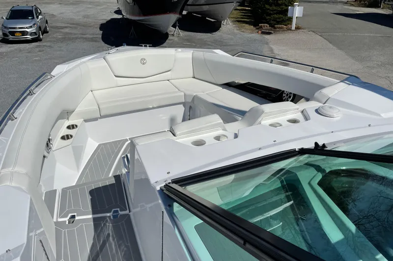 Slide: The Image of 2021 Cruisers Yachts 338 Outboard boat interior with white seating and cup holders. - 7