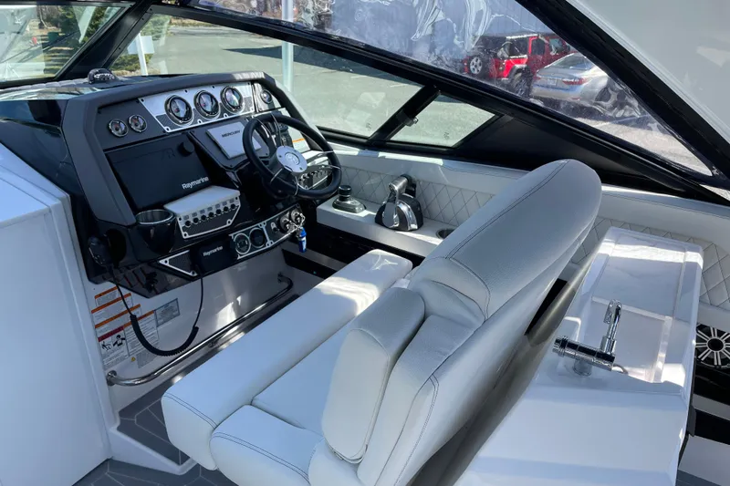 Slide: The Image of 2021 Cruisers Yachts 338 Outboard helm with modern controls and luxurious seating. - 5