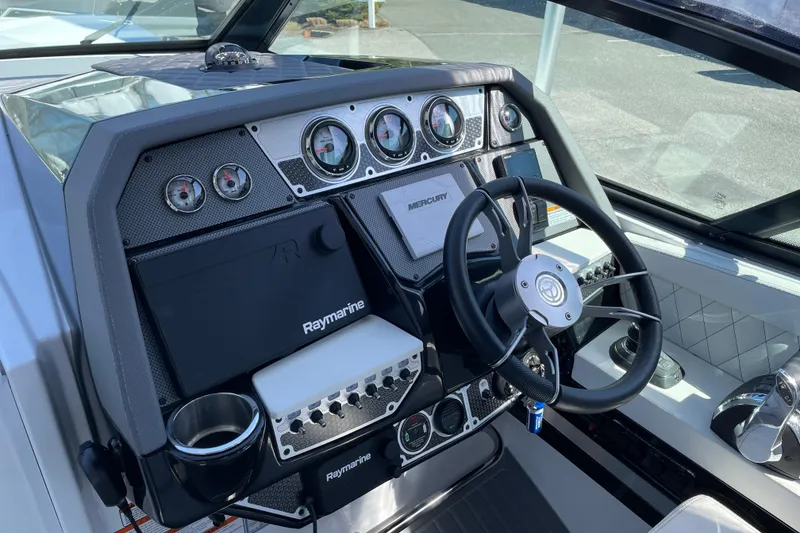 Slide: The Image of 2021 Cruisers Yachts 338 Outboard dashboard with steering wheel and navigation instruments. - 6