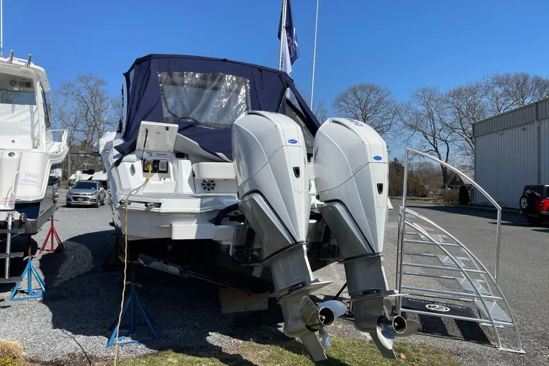 Slide: The Image of 2021 Cruisers Yachts 338 Outboard with dual engines, parked outdoors. - 9
