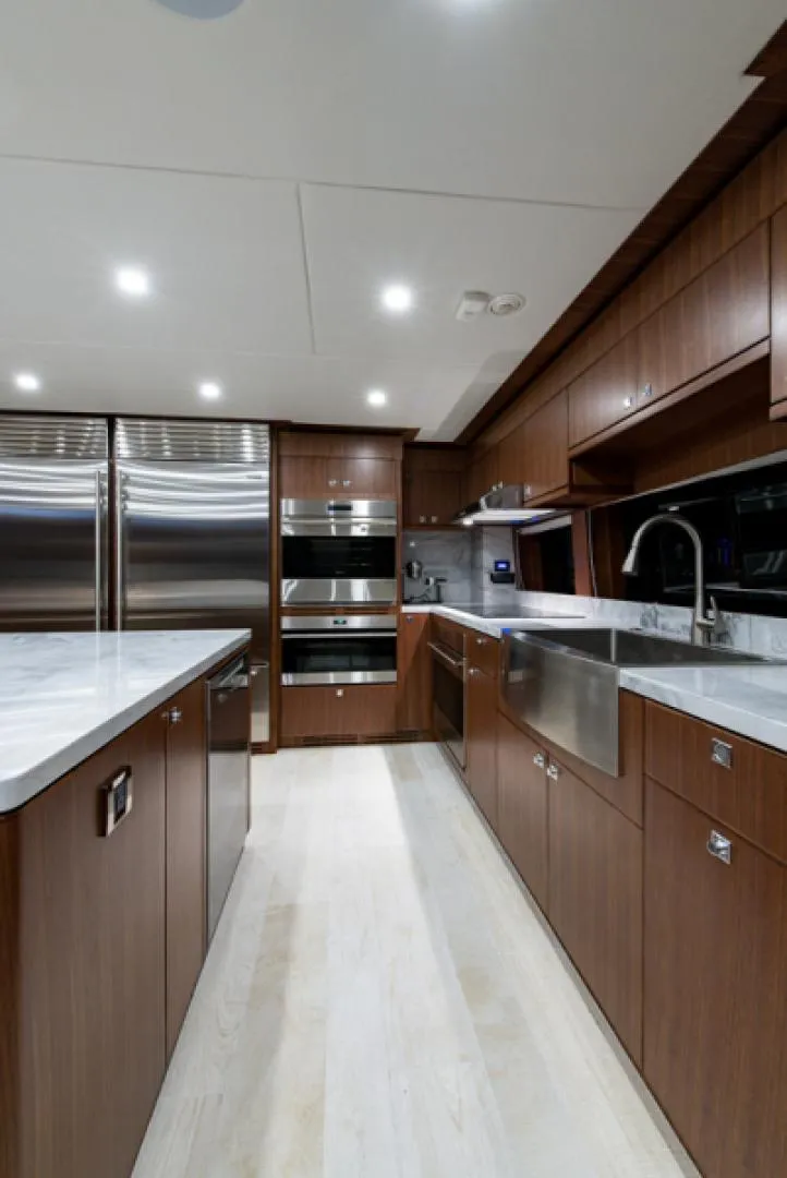 Slide: The Image of Modern kitchen in 2020 Hargrave G120 yacht with stainless steel appliances and wooden cabinetry. - 12