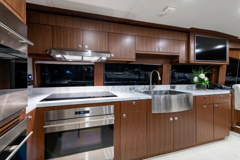 Slide: The Image of Modern kitchen in 2020 Hargrave G120 yacht with stainless steel appliances and wood cabinetry. - 13