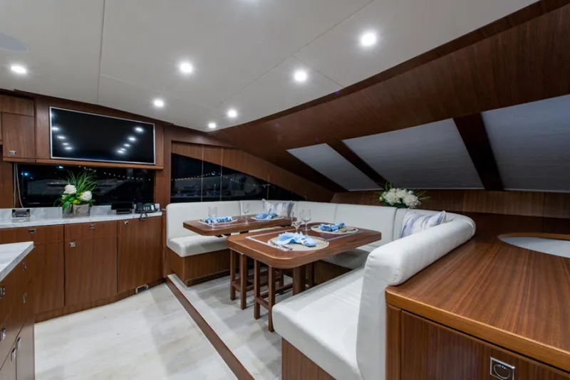 Slide: The Image of Luxurious dining area on a 2020 Hargrave G120 yacht with elegant wood finishes. - 14