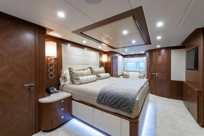 Slide: The Image of Luxurious master bedroom on a 2020 Hargrave G120 yacht with modern decor and ambient lighting. - 19