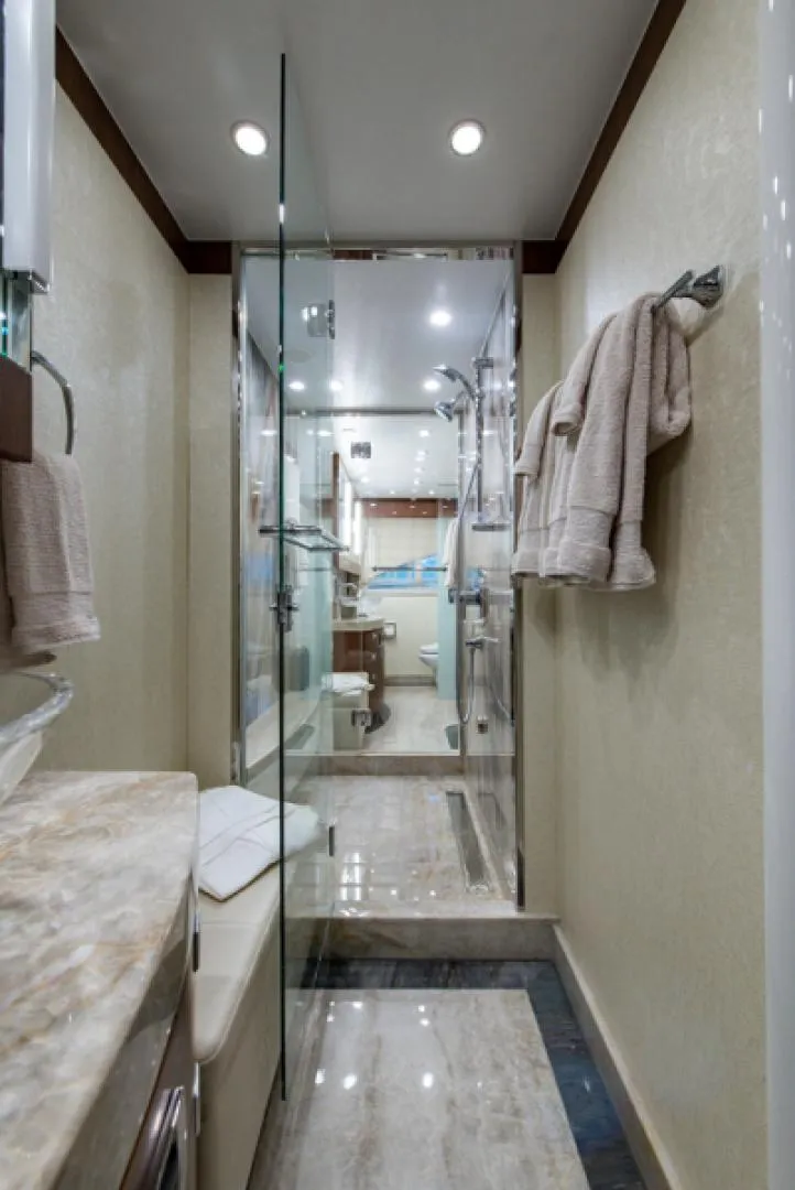 Slide: The Image of Luxurious bathroom in a 2020 Hargrave G120 yacht with glass shower and marble finishes. - 25