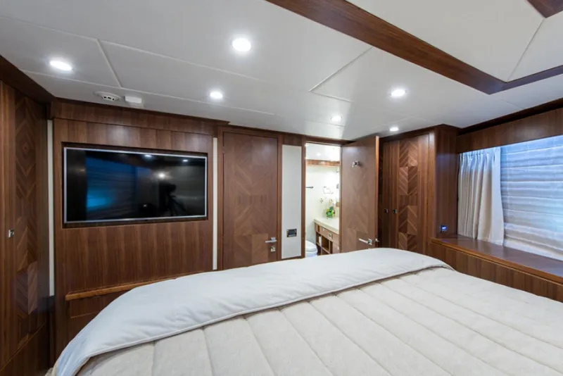 Slide: The Image of Luxurious bedroom interior of 2020 Hargrave G120 yacht with TV and ensuite bathroom. - 44