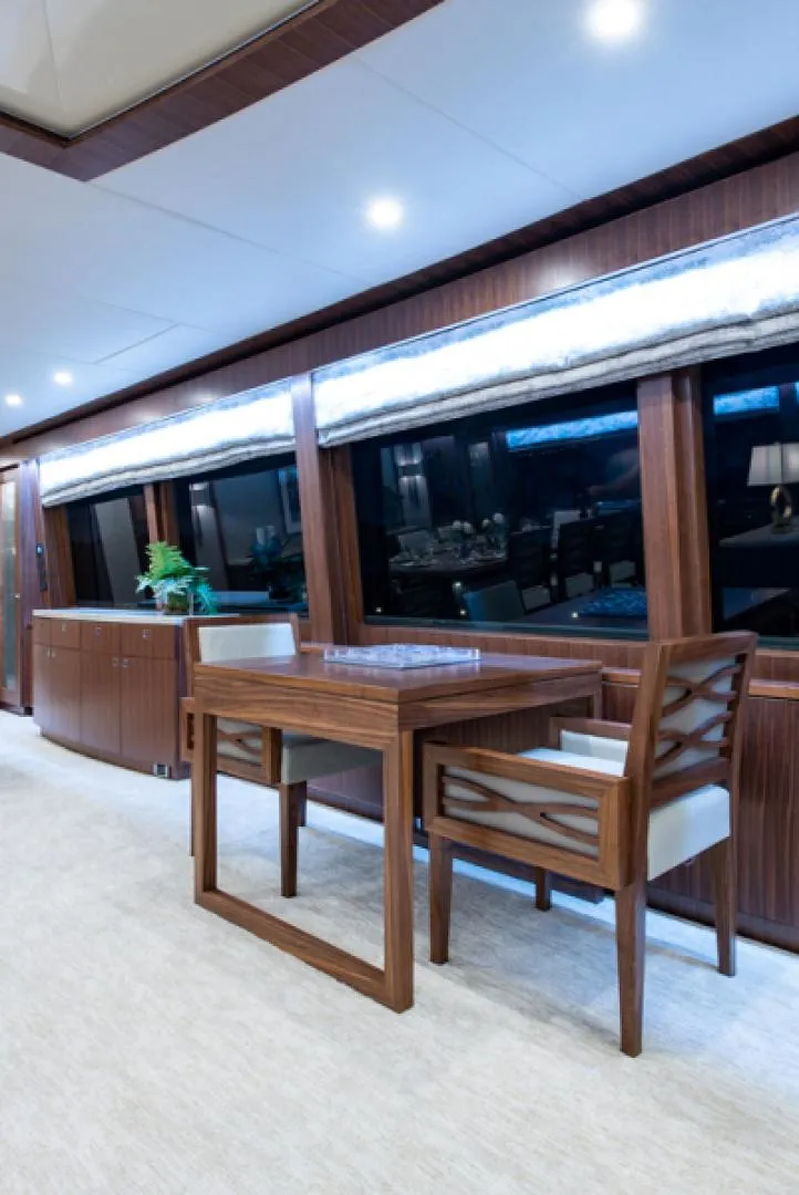 Slide: The Image of Luxurious interior of 2020 Hargrave G120 yacht with wooden furniture and large windows. - 5
