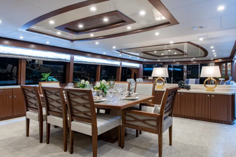 Slide: The Image of Luxurious dining area on a 2020 Hargrave G120 yacht with elegant wooden furniture. - 6