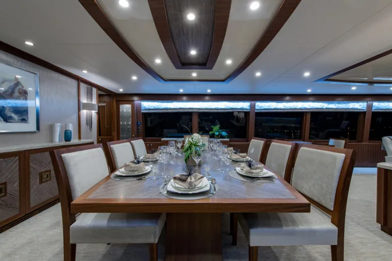 Slide: The Image of Luxurious dining area on a 2020 Hargrave G120 yacht with elegant table setting. - 7