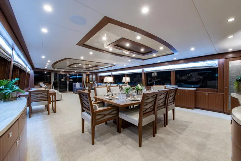 Slide: The Image of Luxurious dining area on a 2020 Hargrave G120 yacht with elegant wooden furnishings. - 8