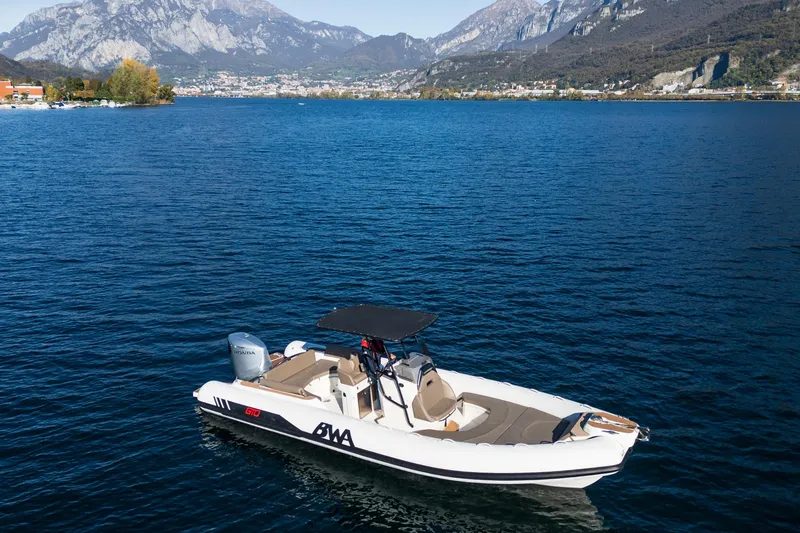 The Image of 2026 BWA GTO 308 boat on a serene lake with mountainous backdrop. - 0