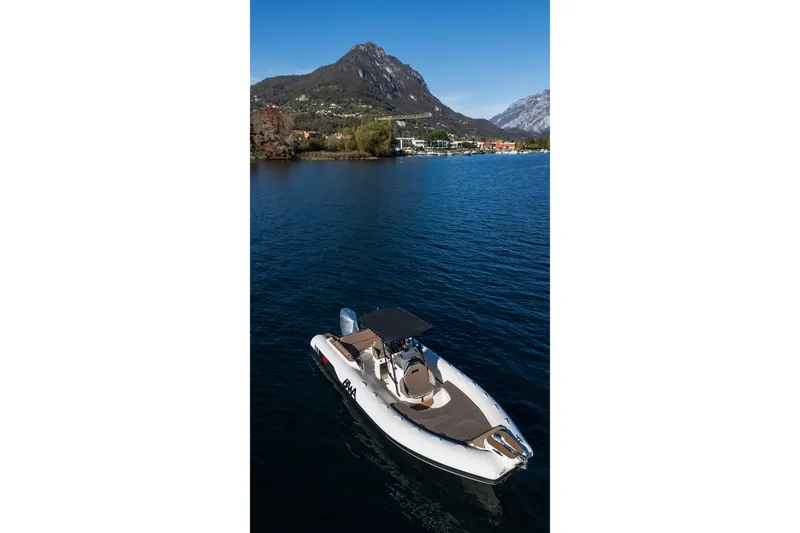 Slide: The Image of BWA GTO 308 boat on a serene lake with mountain backdrop, 2026 model. - 11
