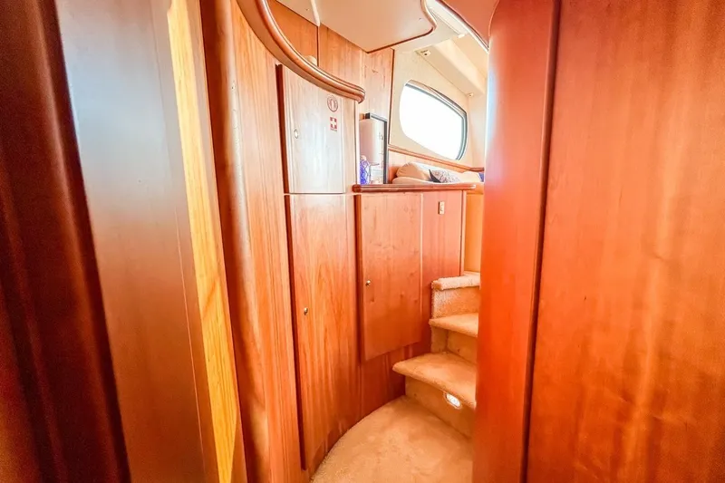 Slide: The Image of Interior of 2003 Silverton 410 Sport Bridge with wooden cabinetry and carpeted stairs. - 107