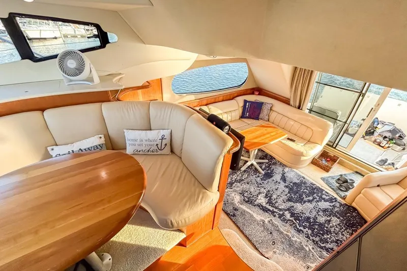Slide: The Image of Interior of 2003 Silverton 410 Sport Bridge yacht with cozy seating and wooden table. - 111