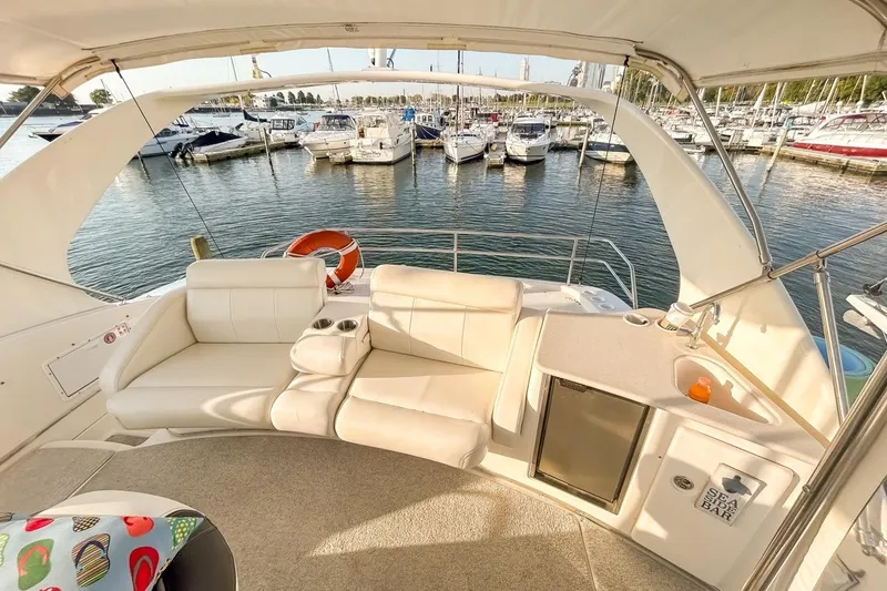 Slide: The Image of Luxurious 2003 Silverton 410 Sport Bridge yacht interior with seating and marina view. - 112