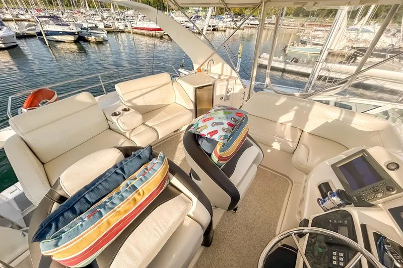 Slide: The Image of Luxurious 2003 Silverton 410 Sport Bridge yacht interior with plush seating and marina view. - 118