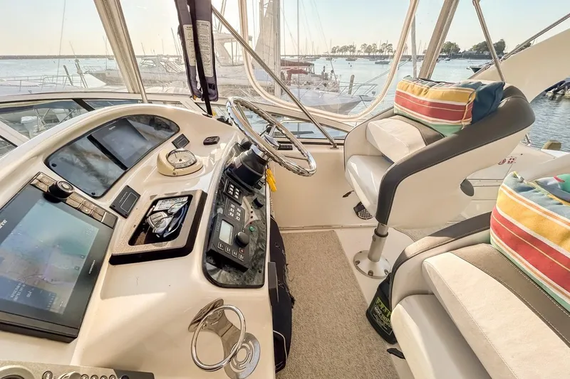 Slide: The Image of 2003 Silverton 410 Sport Bridge helm with modern controls and colorful cushions. - 121