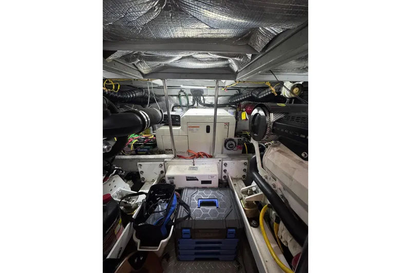 Slide: The Image of Engine room of a 2003 Silverton 410 Sport Bridge with equipment and storage. - 128