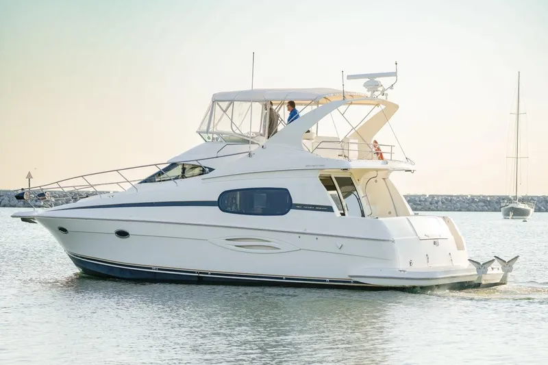 Slide: The Image of 2003 Silverton 410 Sport Bridge yacht cruising on calm waters. - 13