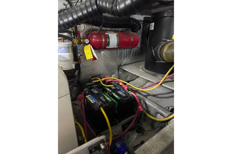 Slide: The Image of Engine room of 2003 Silverton 410 Sport Bridge with batteries and fire extinguisher. - 132