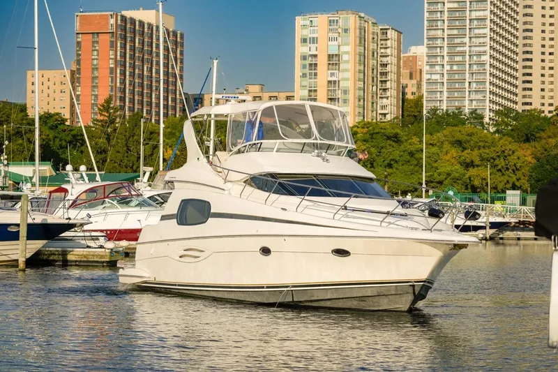 Slide: The Image of 2003 Silverton 410 Sport Bridge yacht docked in urban marina setting. - 2