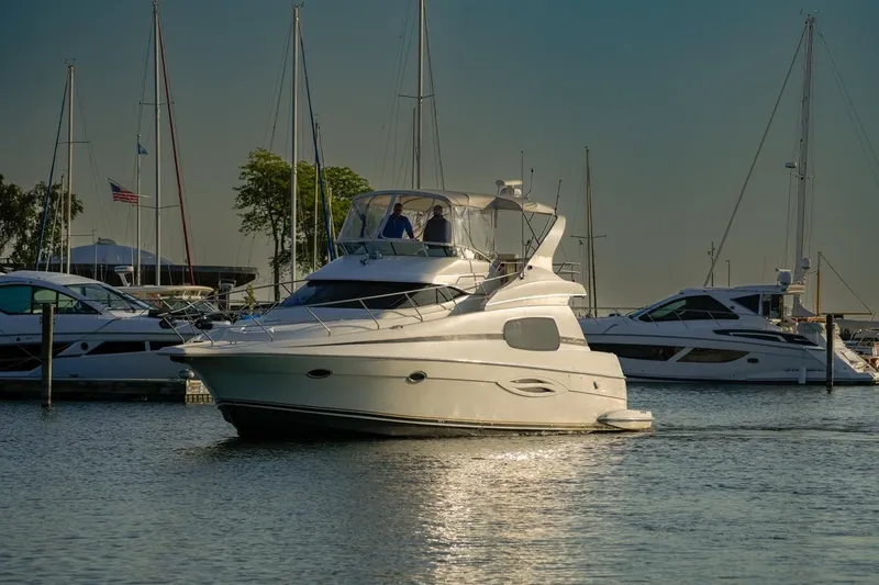 Slide: The Image of 2003 Silverton 410 Sport Bridge yacht in marina, surrounded by other boats. - 24