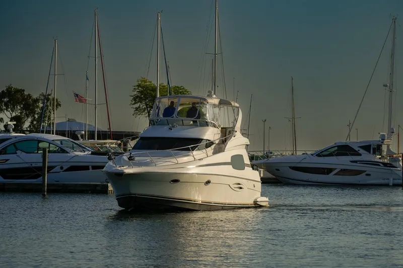 Slide: The Image of 2003 Silverton 410 Sport Bridge yacht docked in a marina with sailboats. - 27