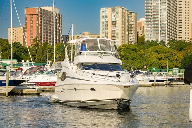 Slide: The Image of 2003 Silverton 410 Sport Bridge yacht docked in urban marina setting. - 3