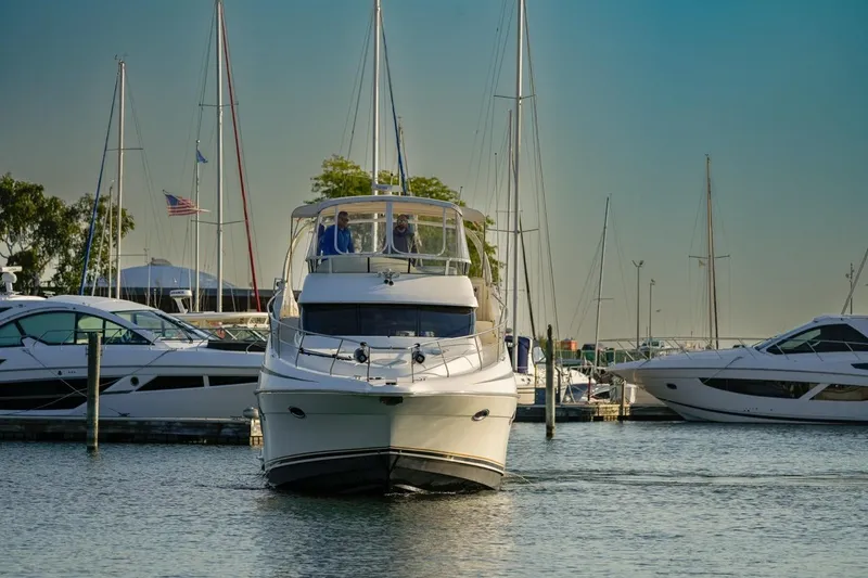 Slide: The Image of 2003 Silverton 410 Sport Bridge yacht docked in a marina with other boats. - 30