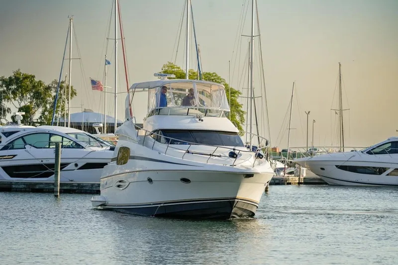Slide: The Image of 2003 Silverton 410 Sport Bridge yacht docked in a marina with other boats. - 33