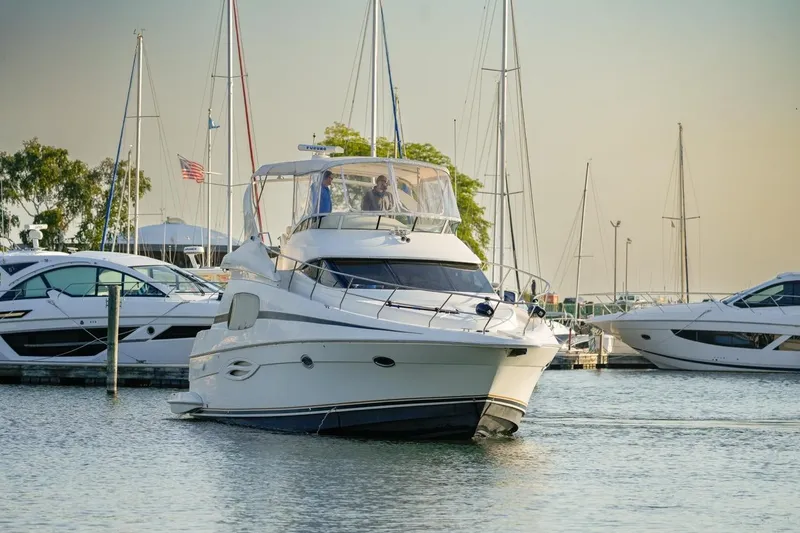 Slide: The Image of 2003 Silverton 410 Sport Bridge yacht docked in a marina with other boats. - 34