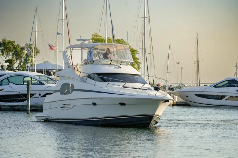 Slide: The Image of 2003 Silverton 410 Sport Bridge yacht docked in a marina with sailboats. - 36