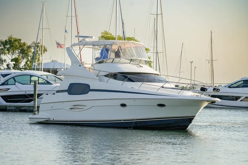 Slide: The Image of 2003 Silverton 410 Sport Bridge yacht docked in a marina, surrounded by other boats. - 39