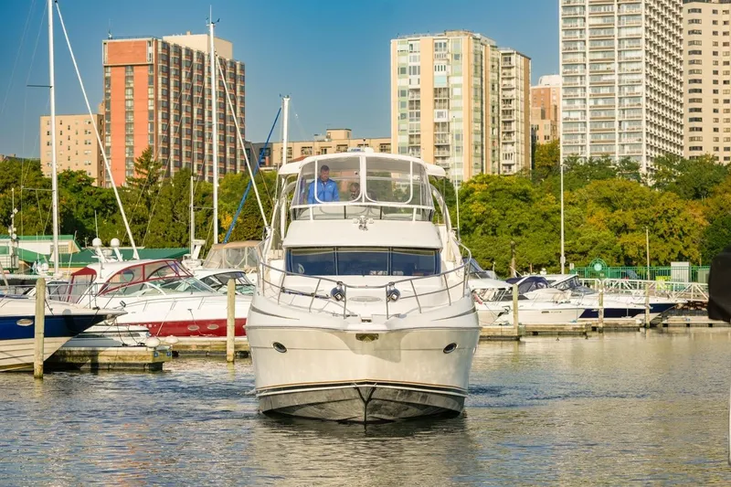 Slide: The Image of 2003 Silverton 410 Sport Bridge yacht docked in urban marina with city skyline. - 4